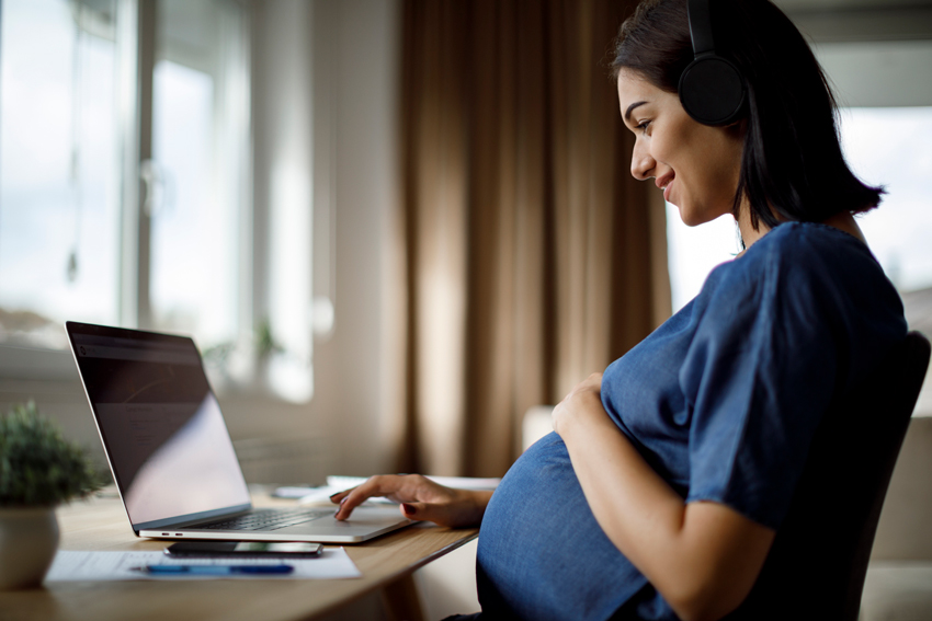 pregnant woman looking at computer