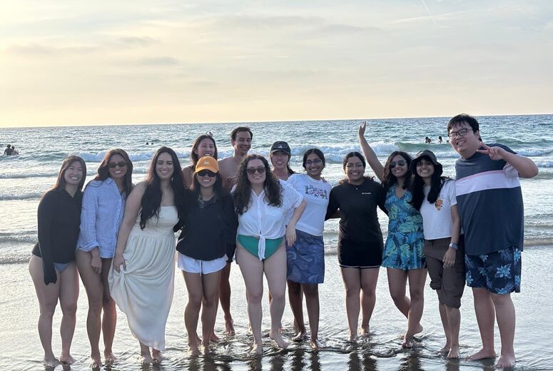 residents taking a group photo at the beach
