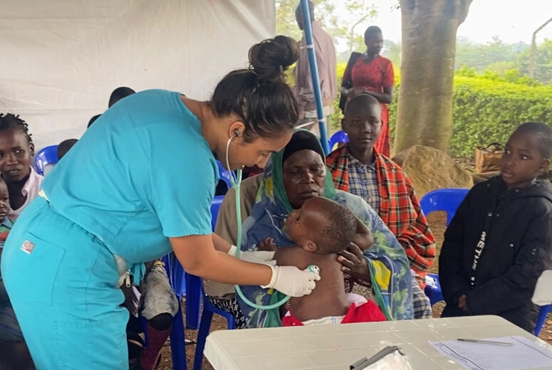 DR. GREENE PROVIDING PEDIATRIC CARE AT A CLINIC IN UGANDA