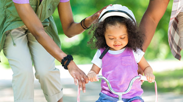 Girl walking with parents 