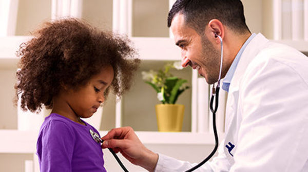 physician checking heart on patient