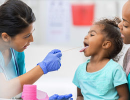 Pediatric health professional providing care to child