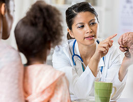 Pediatric Neurologist Discussing Treatment with Family