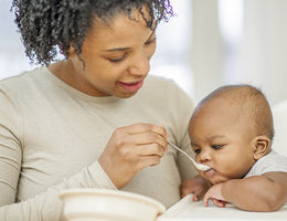 woman feeding baby