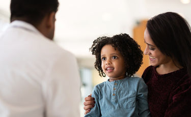 Young patient with mother and doctor 