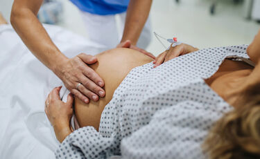 nurse hands on pregnant stomach