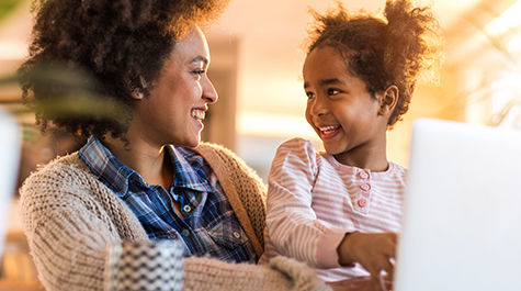 Child sitting with mom smiling